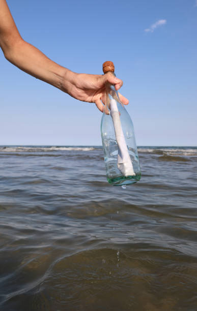 istock boy takes a bottle with a secret message inside 1723914952