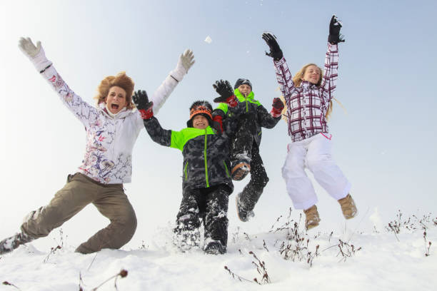 istock Family jumping in snow 1723916333