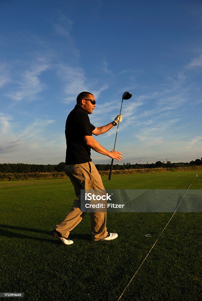 energized golfer energized golfer can&#180;t wait to see where his ball ends, sunset, hamburg. Activity Stock Photo