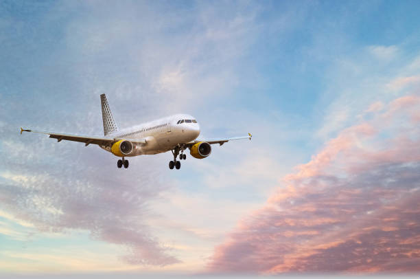 istock passenger plane flies through the clouds. Airplane or aircraft flying at sunset 1723923481