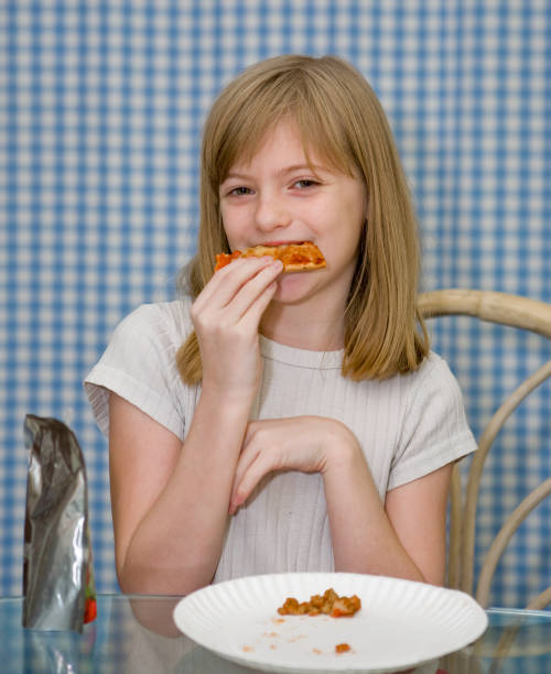 i don't like sausage a young girl eating pizza after she picked all the sausage off dont eat meat stock pictures, royalty-free photos & images