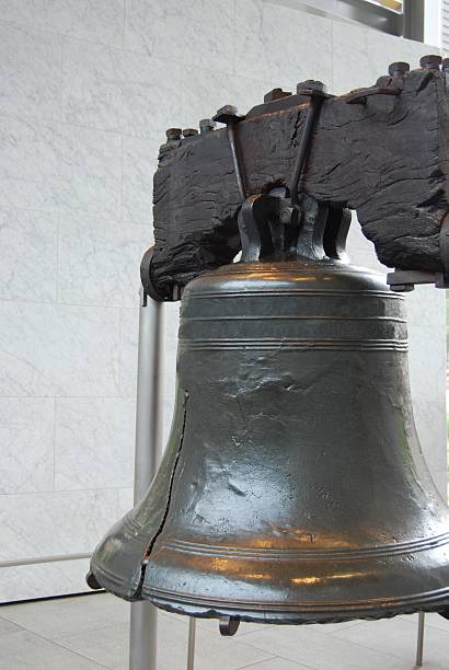 The Liberty Bell Though the crack renders it unable to ring, the Liberty Bell still gleams as it symbolizes unity. Shot in 2007 from inside the monument hall. Previously, the bell had been located outside. cebolla stock pictures, royalty-free photos & images