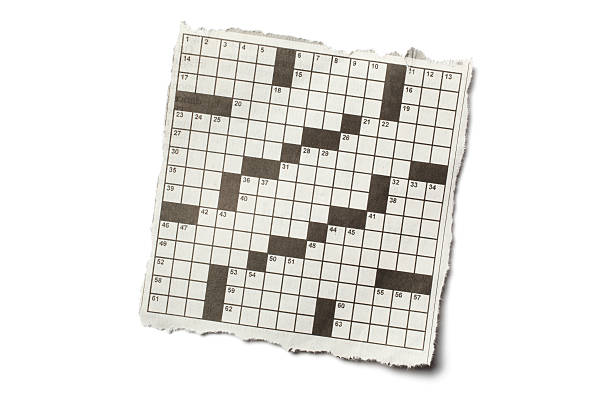 Crossword Puzzle "Torn piece of newspaper crossword puzzle, isolated on white background." crossword stock pictures, royalty-free photos & images