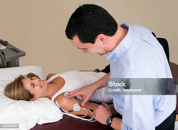 Electrodes Of An Electrical Stimulation Machine On Shoulder Stock Photo - Download Image Now