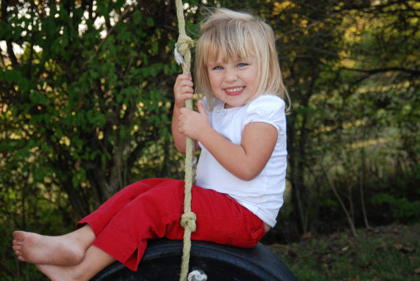 istock Swinging on a Tire Swing 172394147