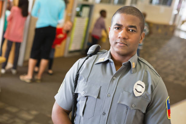istock Confident police officer in elementary school hallway 172394352
