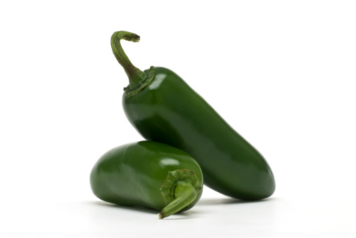 A pair of perfectly fresh jalapeno peppers isolated on white.Click on the banner below to see more photos like this.