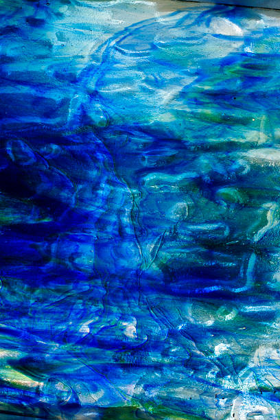 Abstract image of blues and greens on stained glass