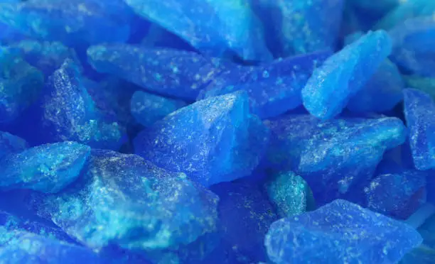 Close up of large copper sulfate crystals, showing a beautiful blue colour