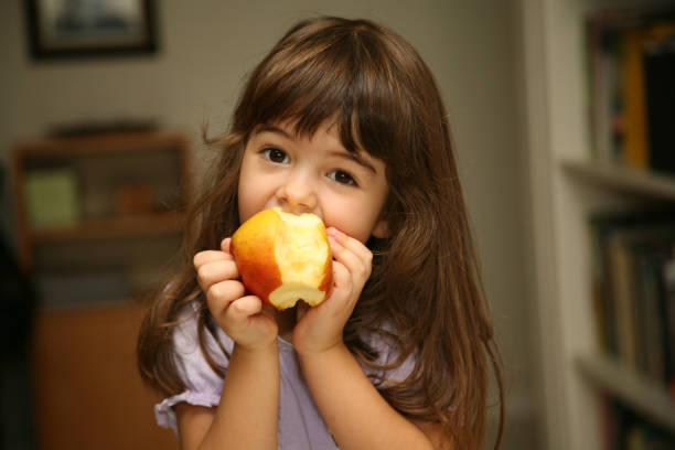 istock girl eating an apple 172396027