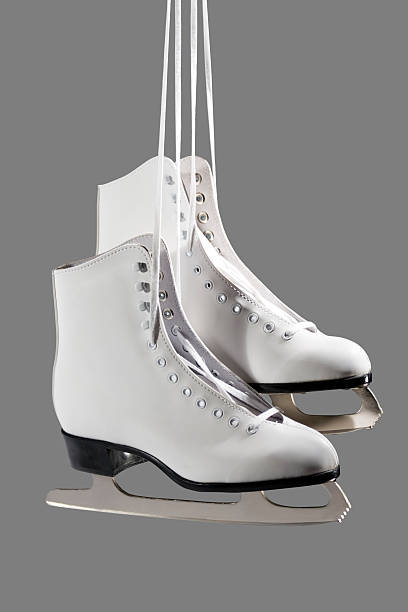 Go Figure Pair of women's white figure skates.clipping path included. hockey skate stock pictures, royalty-free photos & images