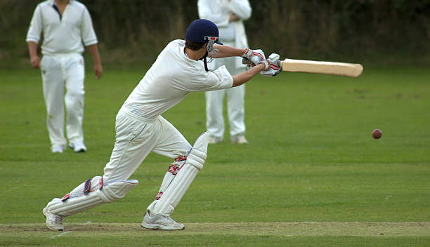 Cricketer playing cut shot A batsman playing a pull shot. cricket player stock pictures, royalty-free photos & images