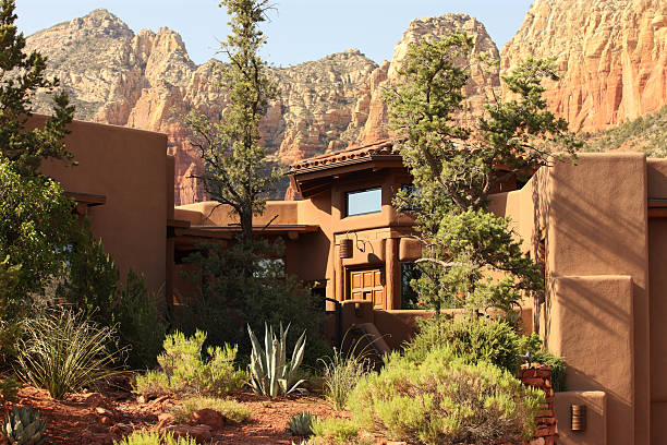 Luxury Mansion Southwest Architecture Front facade of a Southwest style luxury mansion with desert red rock buttes in the background.  Sedona, Arizona, 2012. nook architecture photos stock pictures, royalty-free photos & images