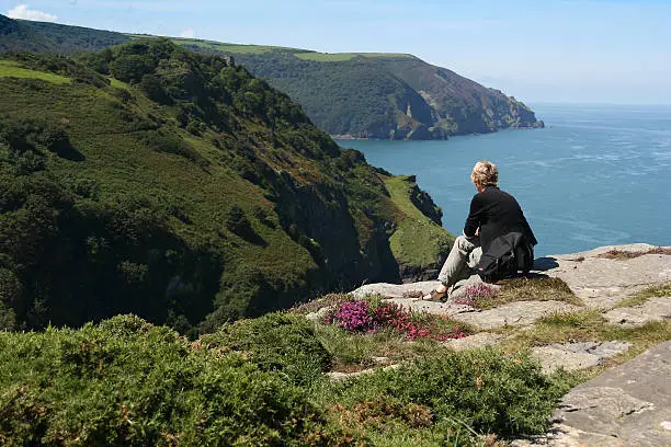 "Women enjoying the beautiful view at the North Devon coastline. Taken at the Valley of Rocks, Devon, England."