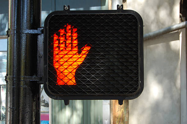 istock A lit-up red hand sign indicating not to walk on crossings 172398101