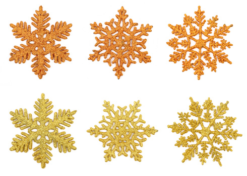Six shiny golden snowflakes on white background. Digital montage