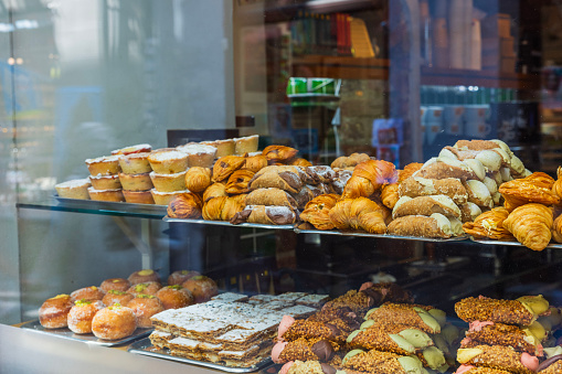 Close-up view of store window with bakery products.