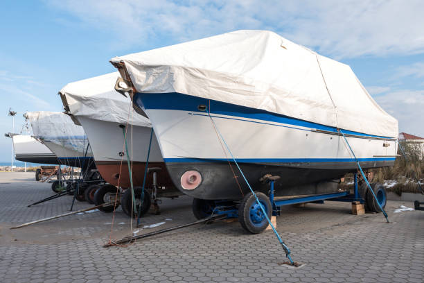 Covered boats on land in Swedish winter. Fiskeback/Onnered.
