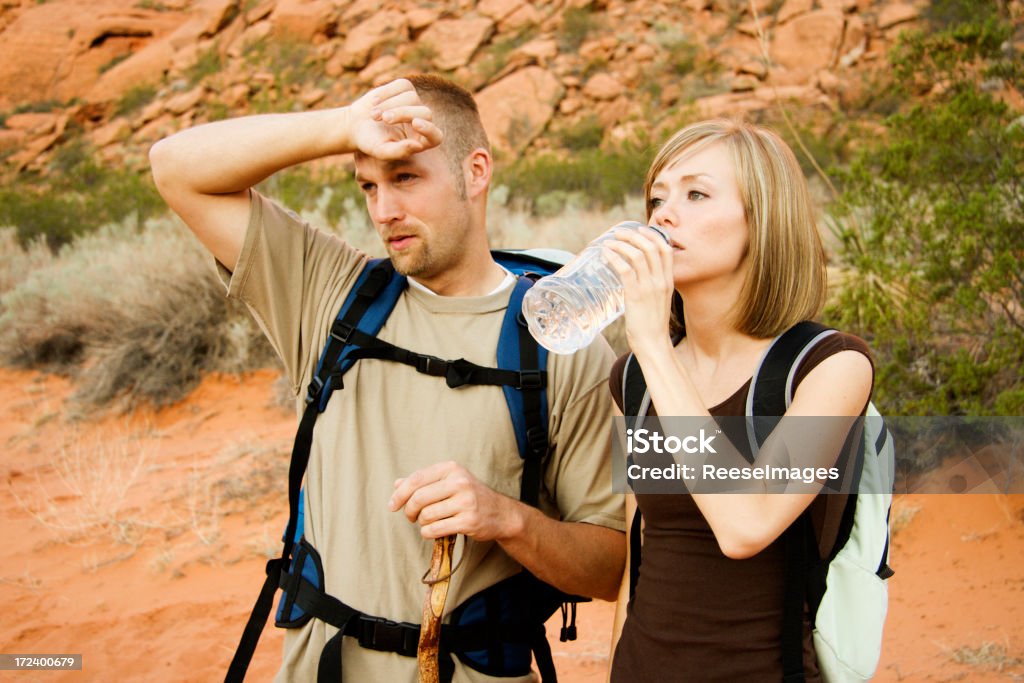 Coppia bere acqua per un'escursione - Foto stock royalty-free di Sudore