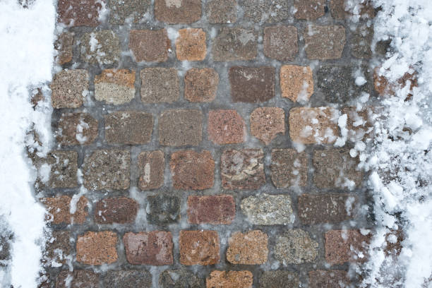 istock icy cobblestone pavement in winter 1724008650