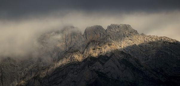 panoramic view of a rocky mountain wall in sunset light