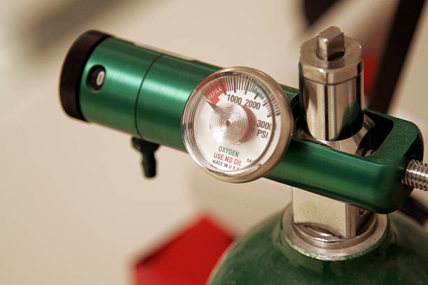 A close-up of the meter of a green oxygen tank Pressure gauge on an oxygen tank. oxygen cylinder stock pictures, royalty-free photos & images