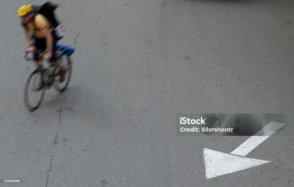 Bicycle messenger follows arrow in San Francisco "A bicycle messenger in downtown San Francisco is seen changing lanes while passing over/near a merge arrow painted on the pavement.Thanx for looking......For more images of San Francisco, please see the following:" Above Stock Photo