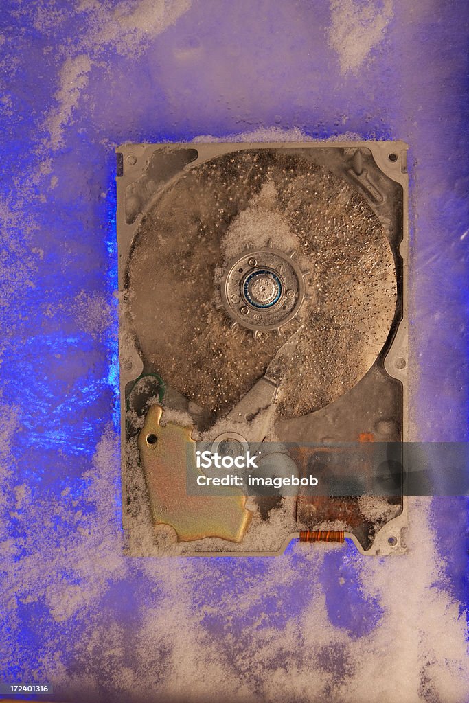 Dramatic Hard drive Hard Drive frozen in ice. Front Lit with 500 watt bulb and floodlight back lit to create bone chilling abstract. Abstract Stock Photo