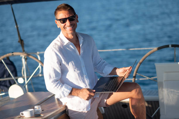 istock Charismatic man in white clothes on a yacht 1724016612