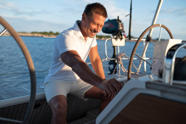 istock Man in white clothes sailing on a yacht 1724016752