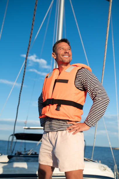 istock Mature man in a life jacket on a yach feeling good 1724017213