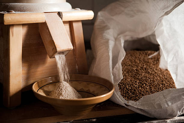 Grinding wheat into flour Small flour mill is grinding spelt wheat into flour. flour mill stock pictures, royalty-free photos & images