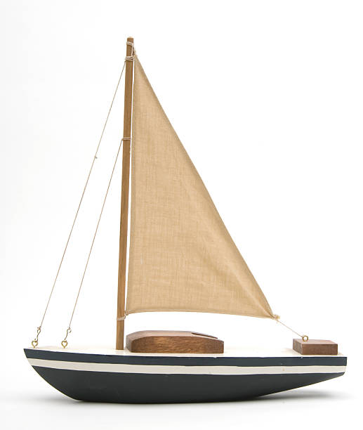 Toy boat with a large brown sail stock photo