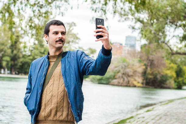 istock Young man taking a selfie on the public park 1724022166