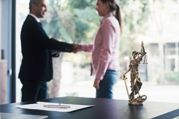 istock Lawyer and client shaking hands 1724023462