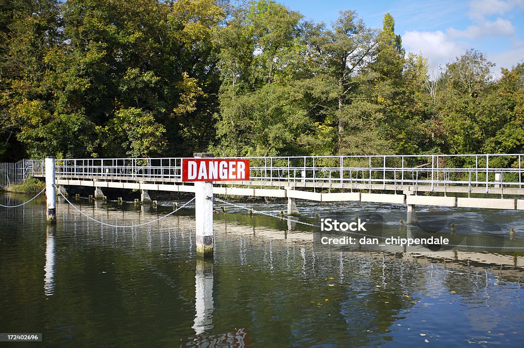Weir Weir on a river with danger sign Autumn Stock Photo