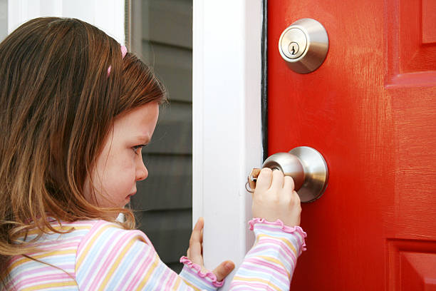 istock Little girl unlocking a red door 172403780
