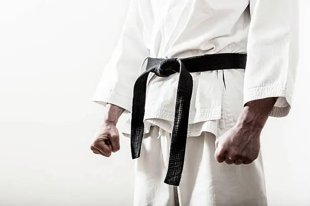 Photo of Up close of a martial arts black belt worn on ready fighter