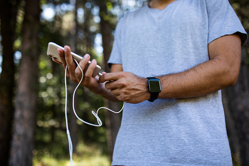 Man connecting the headphones into the smartphone