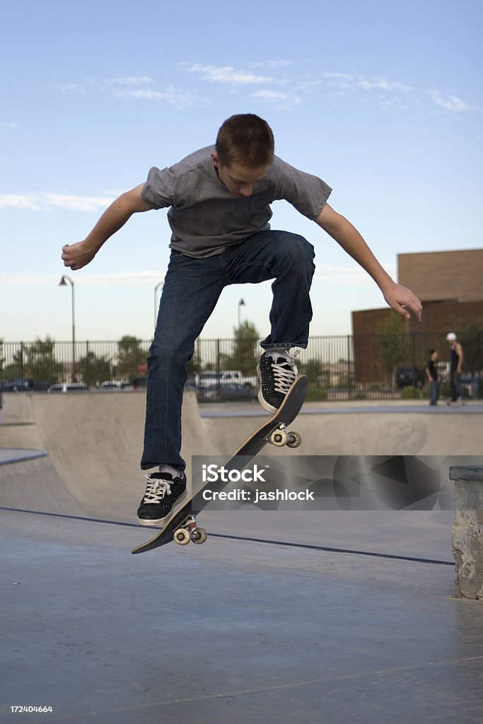Skaterboy Young boy flipping skateboard at skatepark Activity Stock Photo