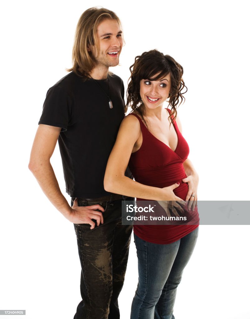 Happy news Happy young couple announcing the new baby to come. Concepts: friendship; parenthood; pregnancy; relationship. White background. Adult Stock Photo