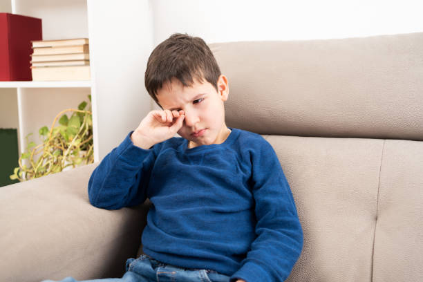 child scratching his itchy eye