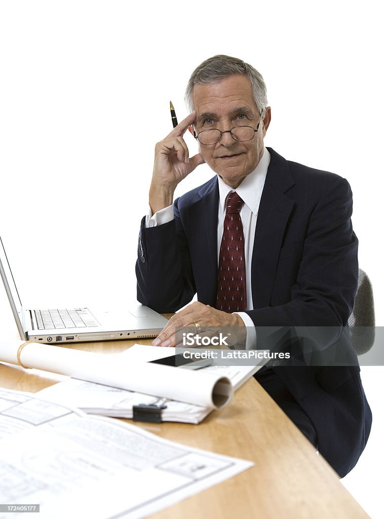 Senior empresario lleva Gafas en escritorio con papeles de estar - Foto de stock de Hombres mayores libre de derechos