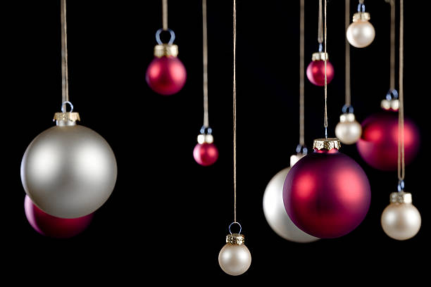 istock red and silver hanging Christmas ornaments isolated on black 172405284