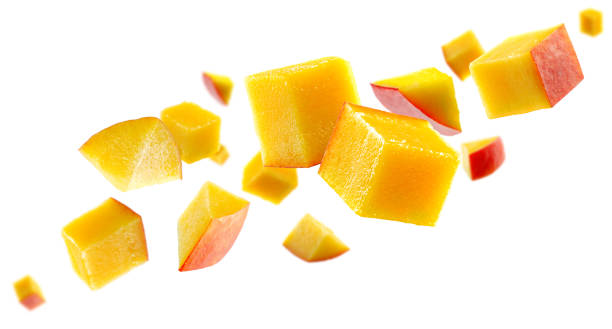 istock Mango cubes fly in space forming a chain shape. Volumetric light from behind. Isolated on white. 1724053843