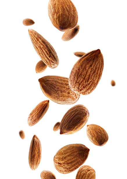 istock Perfectly retouched almond falls in space. Volumetric back light. Isolated on white. 1724054850