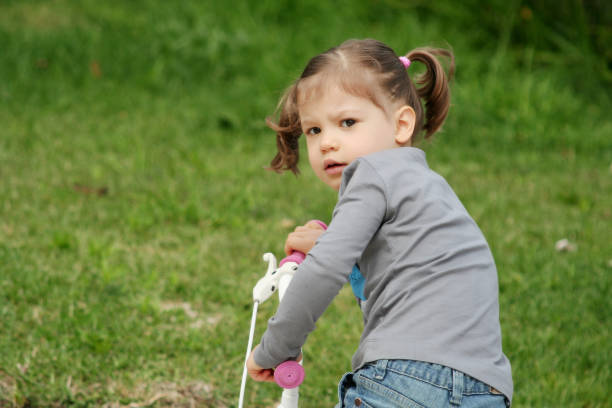 three year old Little Girl ridding a bicycle