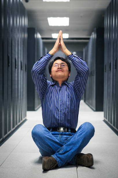 istock business man practice yoga at network server room 172405556