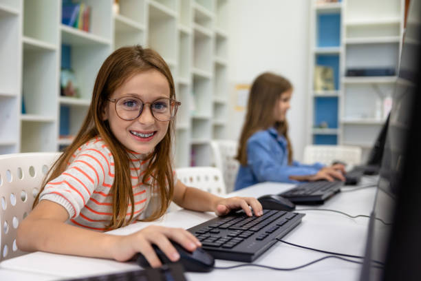 istock Little girl studying in school library. 1724057302