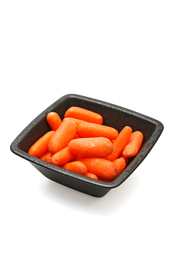Bowl of baby cut carrots isolated on a white background. Includes clipping path.